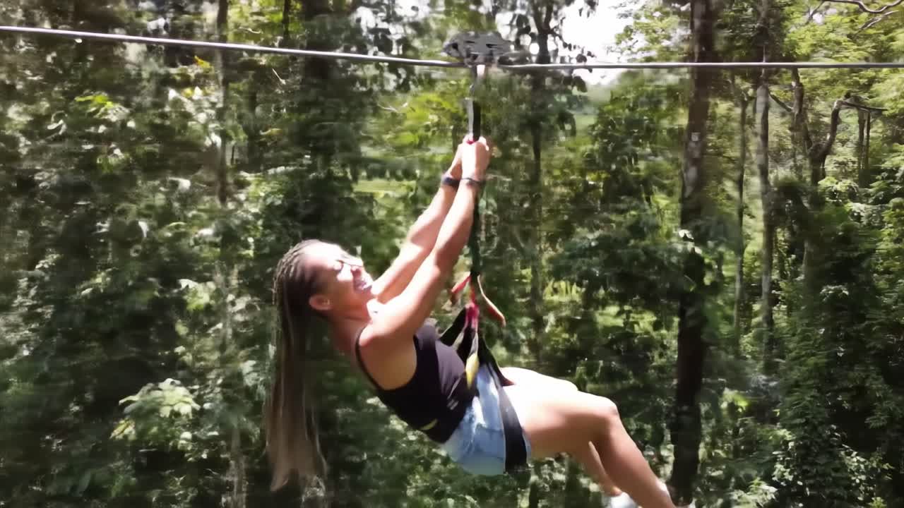 Thrill-Seeker Experiencing the Adrenaline Rush of Zip Lining Through Lush Green Forests as They Glide Smoothly Above the Vibrant Canopy Below
