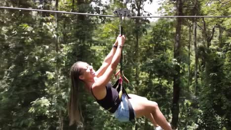 thrill-seeker experiencing the adrenaline rush of zip lining through lush green forests as they glide smoothly above the vibrant canopy below