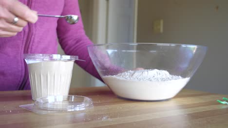 adding yeast to big bowl of ingredients - slow motion making scones