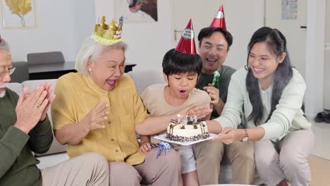 a family gathers around a birthday cake, sharing smiles and laughter in a warmly lit living room