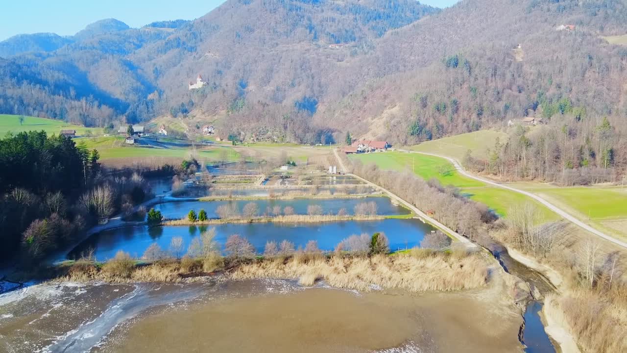 Aerial forward view of Zovnek lake and surrounding landscape. Slovenia