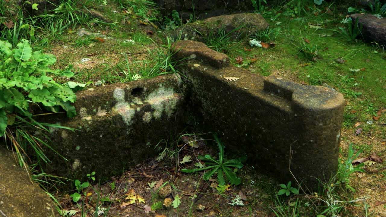 Ancient ruins with stone structures in Castro Cibdá de Armeá, Ourense, Galicia, surrounded by nature