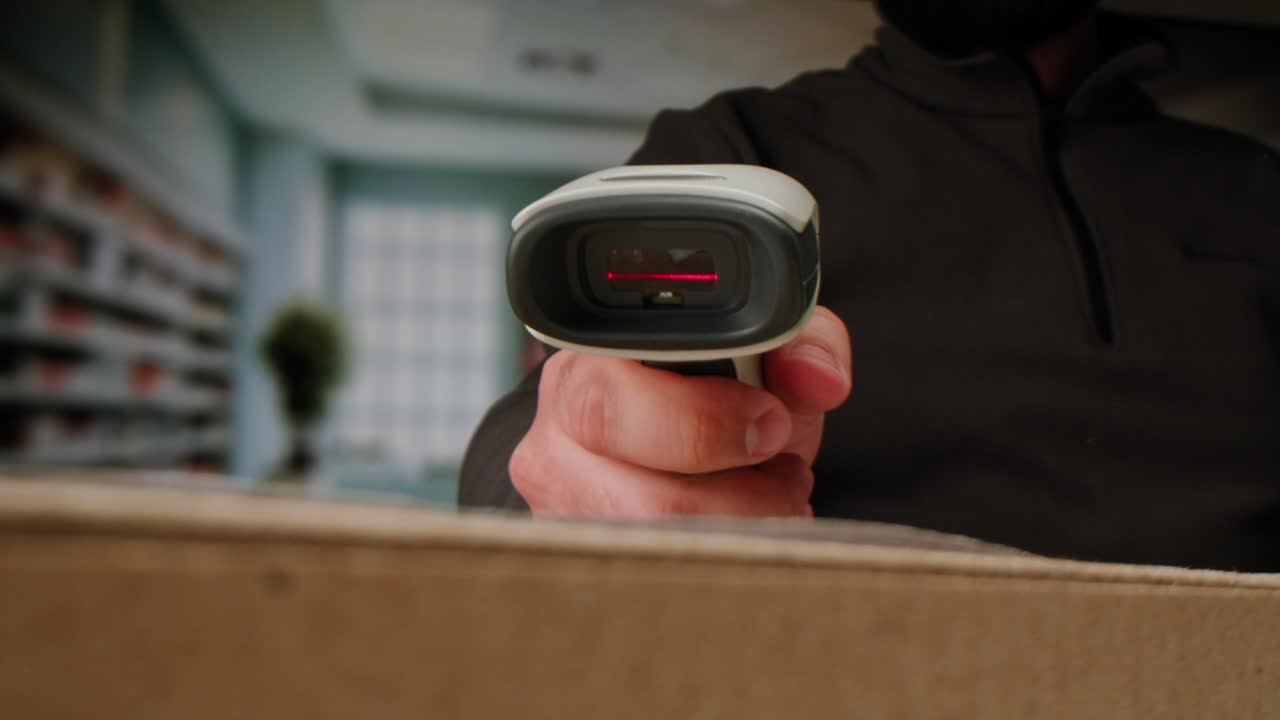 Scanner scan delivery box in storage, E-commerce shop, man packing goods and clothes second hand delivery market, courier Packaging and Shipping Workspace with Supplies and Technology, online sales.