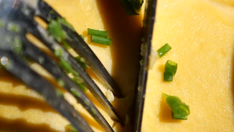 close-up of an omelette with chives being served