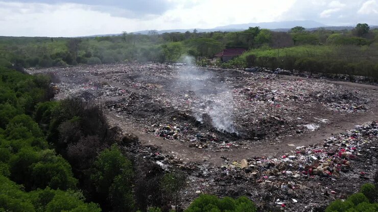 Rubbish tip, landfill, waste area in Lembongan Bali low fly in drone shot