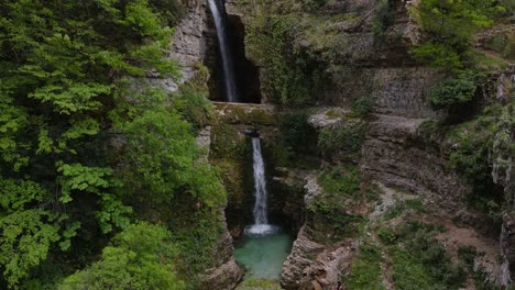 aerial ascending view of the ujëvara and peshturës waterfalls in albania, offering a breathtaking natural spectacle