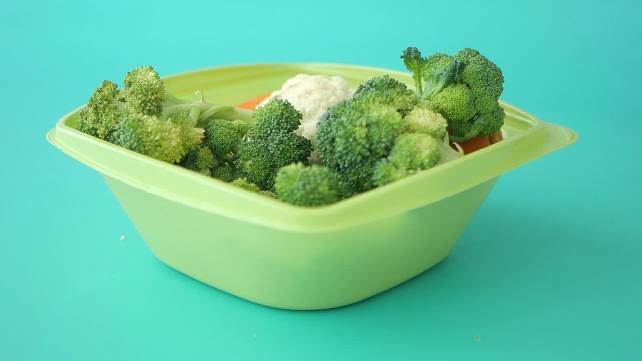 Fresh Broccoli, Cauliflower, and Carrots in a Green Bowl