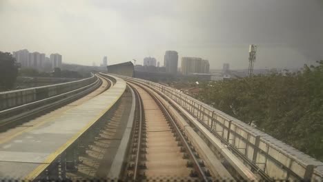 kuala lumpur, malaysia -july 8, 2019: passengers record the mass rapid transit movement from the back of the train