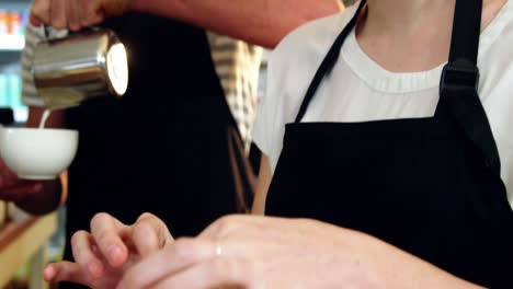 waitress wrapping sandwich with a wax paper