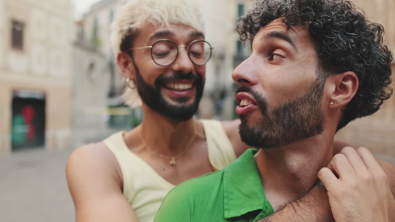 Happy Gay Couple Hugging and Smiling on City Street