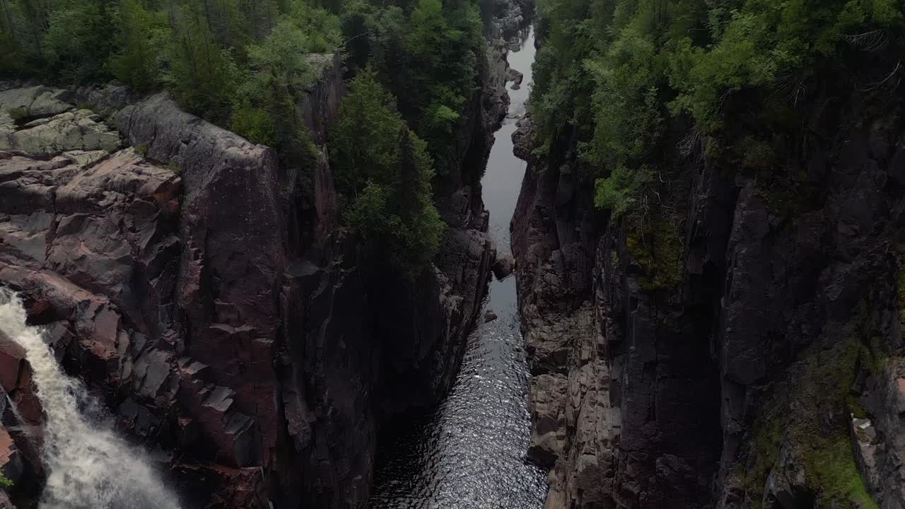 Dramatic Waterfall and River Flowing Through a Canyon Gorge