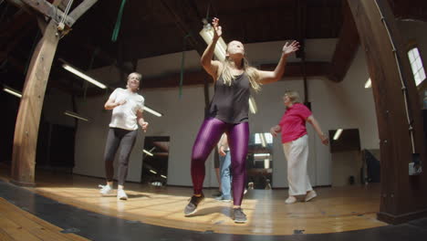 Long-shot-of-people-having-dance-class-with-teacher-in-studio