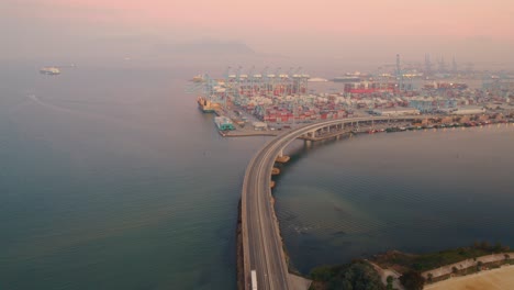 aerial view moving foward of algeciras port, close to the container terminal and the bridge that connects to the port