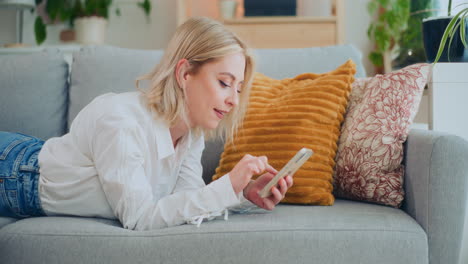 Self-Confident-Girl-Browses-Internet-on-Sofa