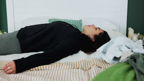 a woman relaxing on her bed