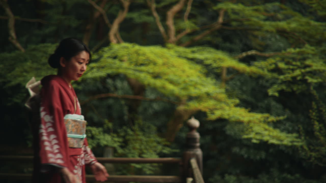 Woman in Kimono in a Japanese Garden
