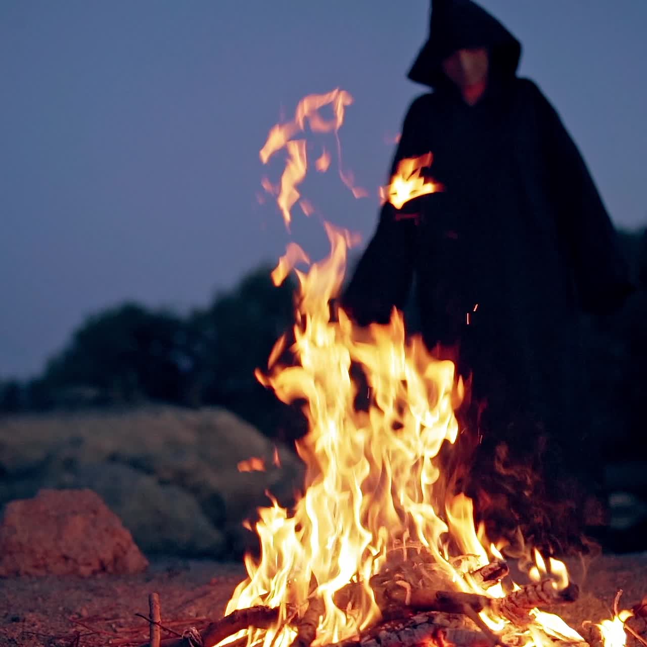 Man in cassocks by the fire