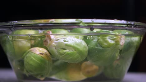 washing brussels sprouts in a bowl