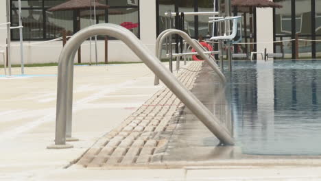outdoor swimming pool with handrails