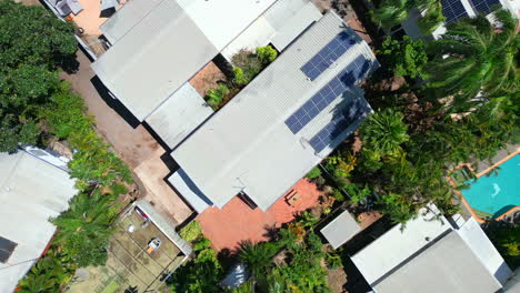 aerial drone of urban elevated modern apartment complex with solar panels on sunny day, ascend rotate top down