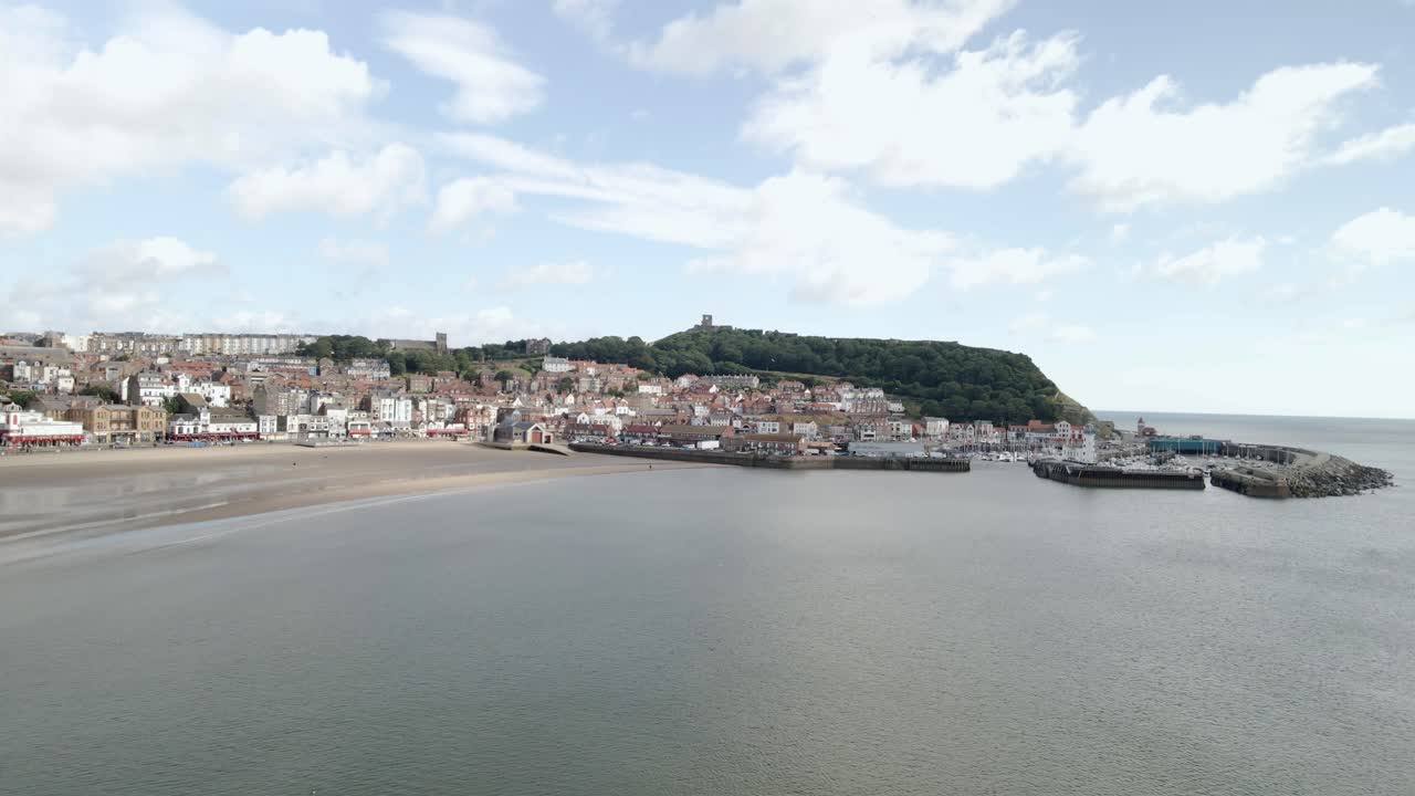 Aerial bird's eye view of Scarborough south bay town, beach, harbor and castle