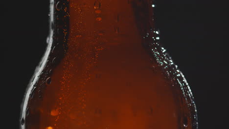 Close-Up-Of-Condensation-Droplets-Running-Down-Revolving-Bottle-Of-Cold-Beer-Or-Soft-Drink-1