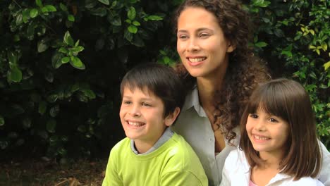 pretty woman posing for photo with her two children