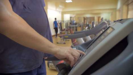 Man-finishing-his-workout-on-treadmill