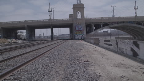 bridge in the industrial area of downtown los angeles next to the la river looking at abandoned train tracks california usa