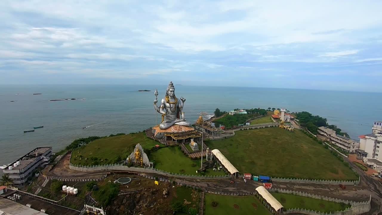 god statue aerial shots with arabian sea in the background at morning