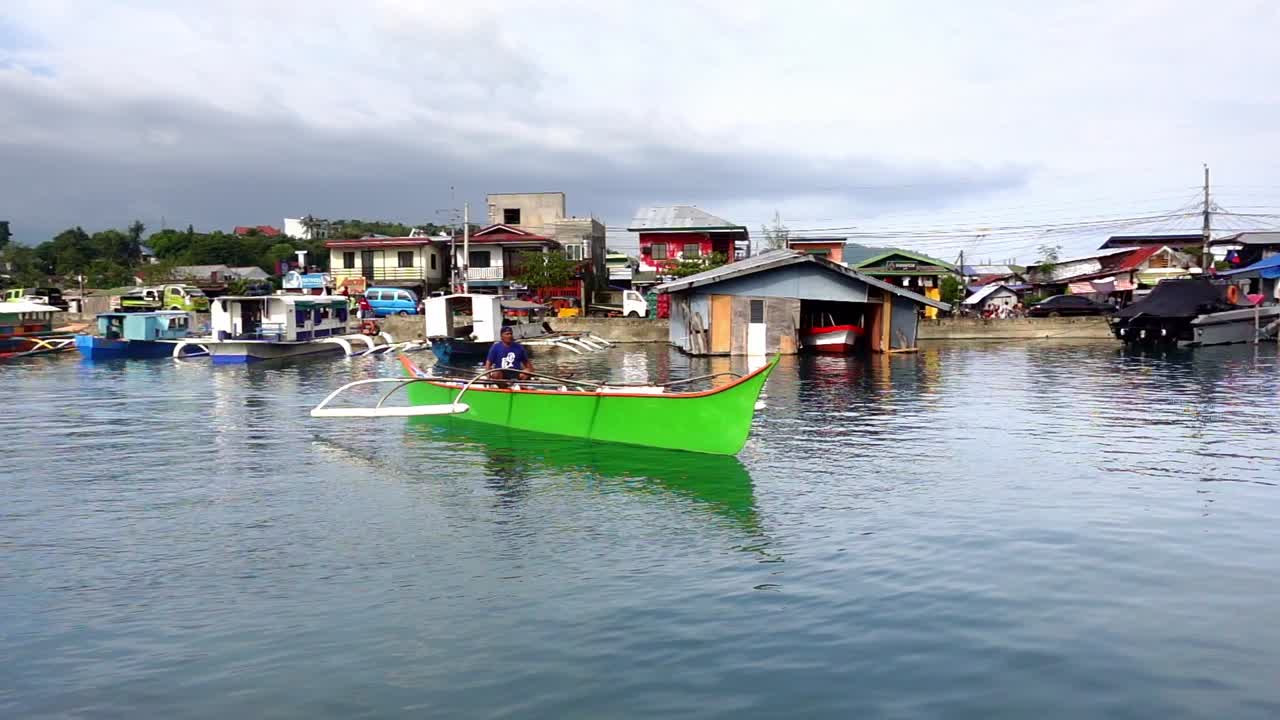 Man in a Green Boat in a Philippine Village