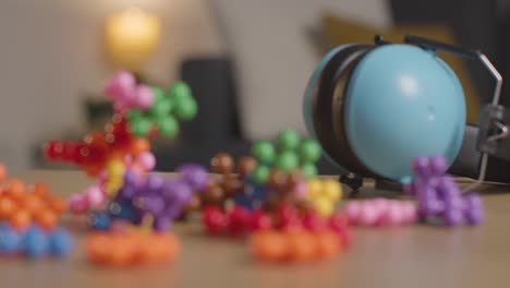 ear defenders and interlocking shape puzzle on table at home for child diagnosed with asd 5