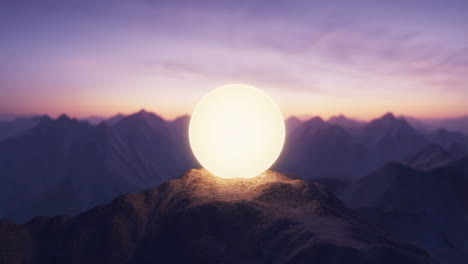 glowing orb on mountain peak at sunset