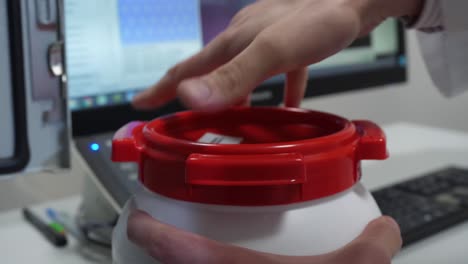científico manejando un frasco en un laboratorio