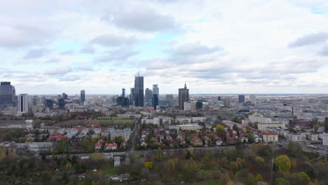wide rising aerial shot of warsaw business district on a cloudy day