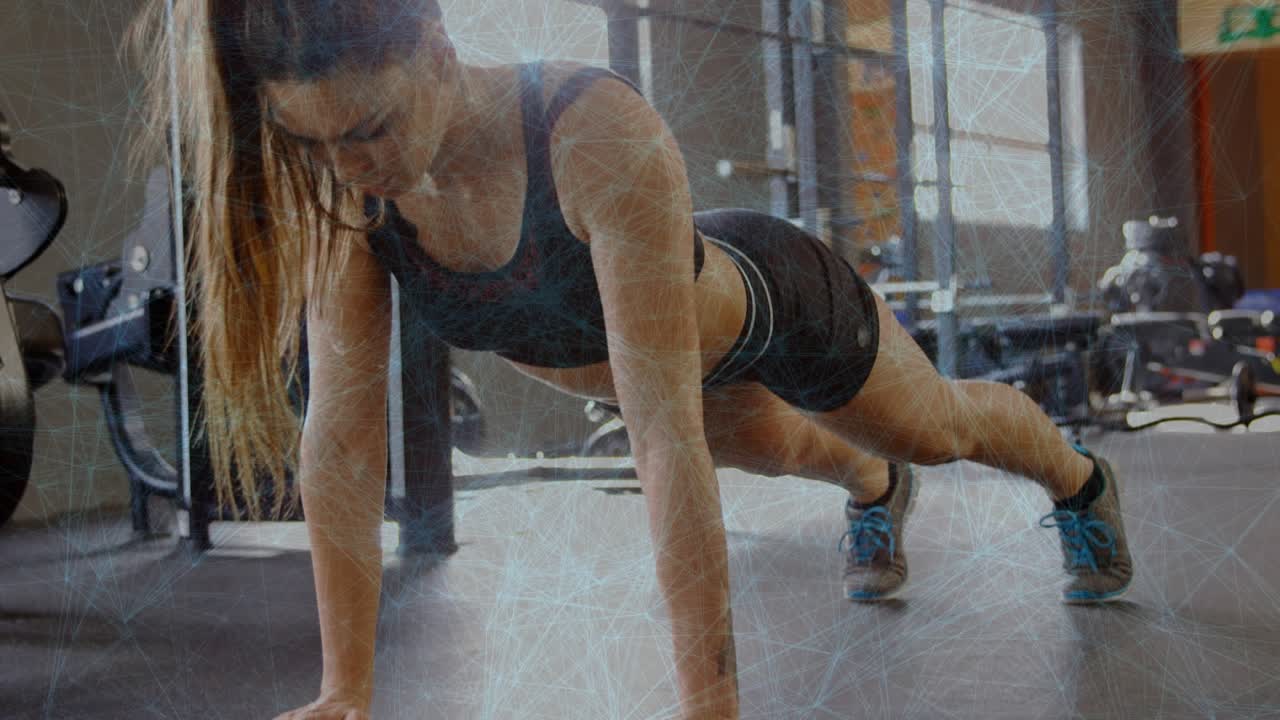 Woman starting high plank and lowering chest toward rubber mat then pushing up for gym strength