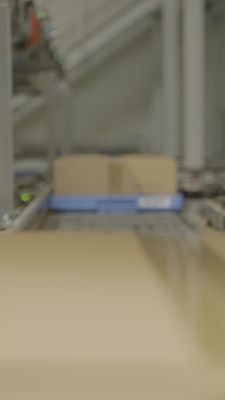 Boxes moving on a conveyor belt in a factory setting