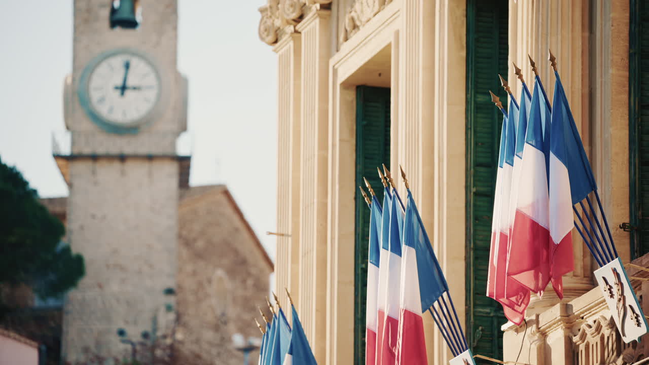 Campo lungo di un edificio storico decorato con bandiere tricolori francesi in una giornata limpida