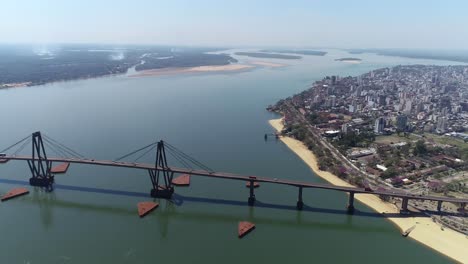 Panoramic-view-of-the-Parana-River,-the-Manuel-Belgrano-Bridge,-and-the-cityscape-of-Corrientes-in-Argentina