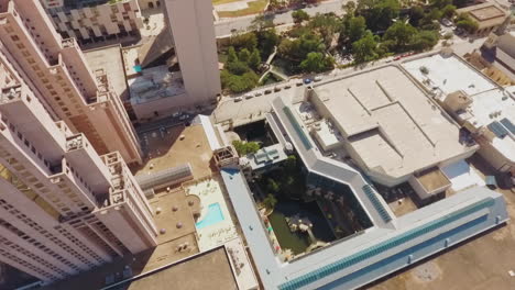 Above-the-San-Antonio-Texas-famous-The-Riverwalk-in-the-afternoon-with-boats-and-restaurants-with-colorful-umbrellas-and-tourists