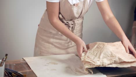 woman working on pottery