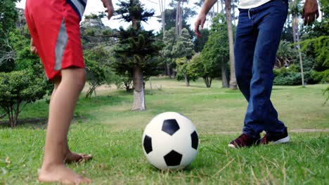 father and son playing football