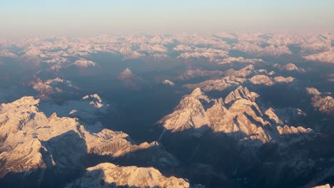 Aerial-view-of-the-sunrise-over-the-snow-capped-European-Alps