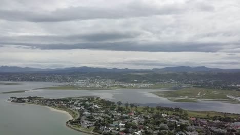 Knysna-River-Lagoon,-quiet-Leisure-Isle-and-surrounding-hills,-aerial