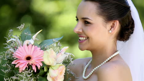 beautiful bride smiling at camera in the park