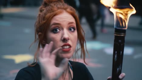 A young woman holding a flaming torch, expressing excitement and intensity in a vibrant urban setting, showcasing her captivating emotion and the power of fire.