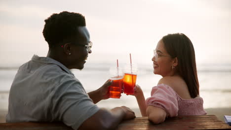 couple enjoying drinks on the beach