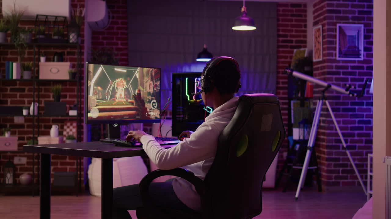 Over shoulder view of gamer streaming multiplayer first person shooter angry after losing online competition