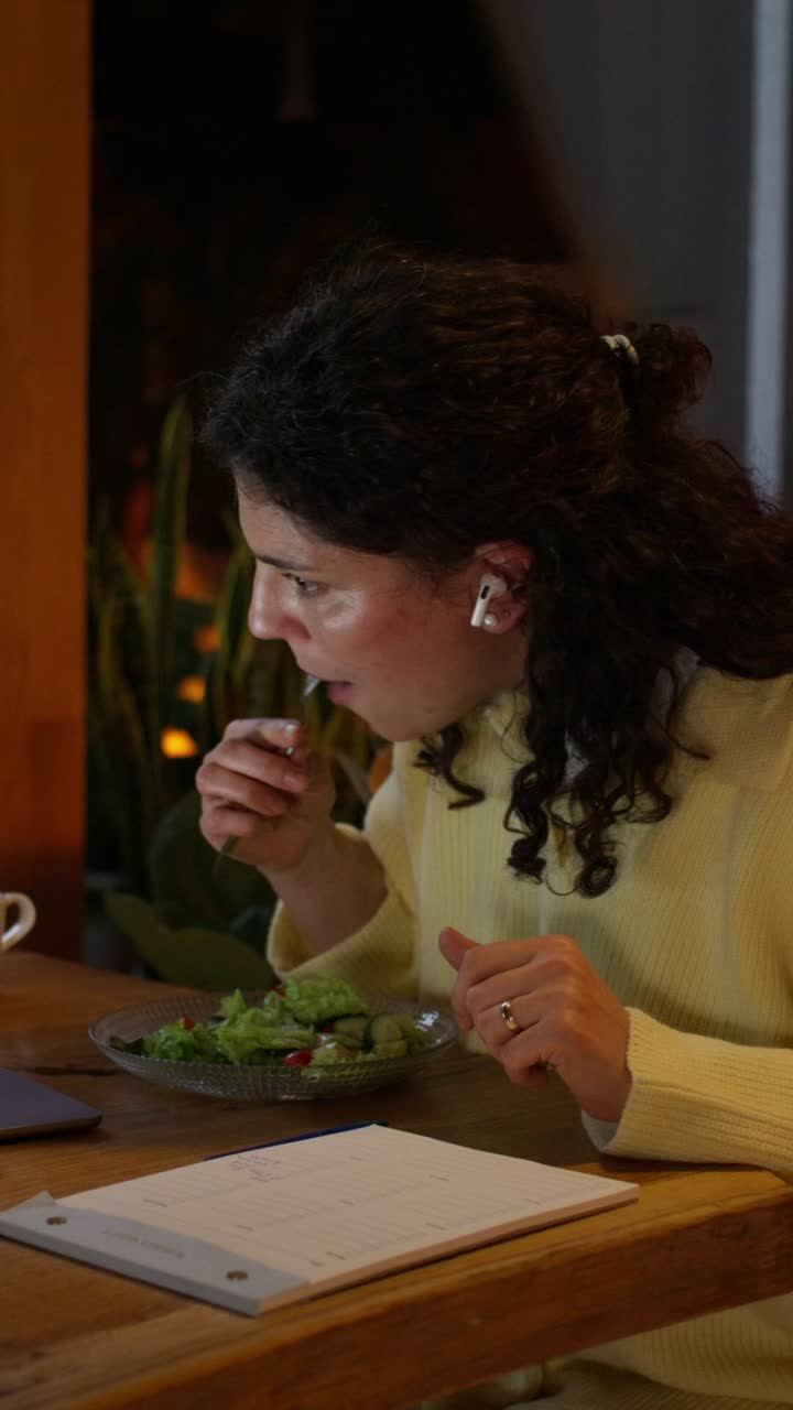 Woman eating lunch and having a video call
