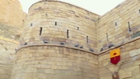 heritage-fort-entrance-gate-with-kingdom-flag-from-flat-angle-shot-is-taken-at-jaisalmer-fort-rajasthan-india-on-Jan-25-2023